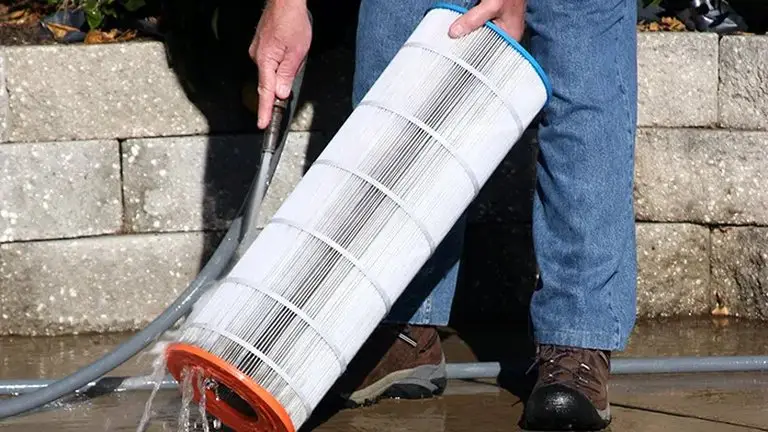 Pool filter cartridge cleaned to fix cloudy pool water that will not clear in Atlanta GA