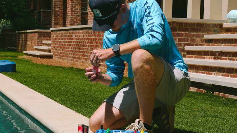 BluVantage technician testing pool water chemistry during a weekly maintenance visit in Metro Atlanta