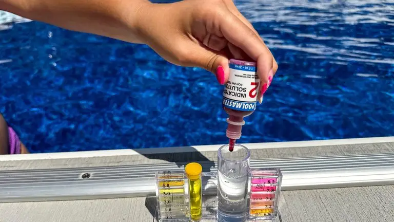 Testing free chlorine and pH with a drop kit at a salt water pool in Atlanta GA