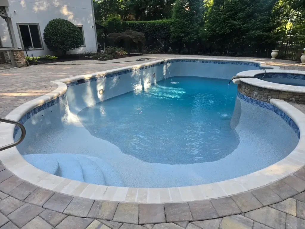 After: renovated pool with a new blue interior finish, waterline tile and coping in Atlanta, GA